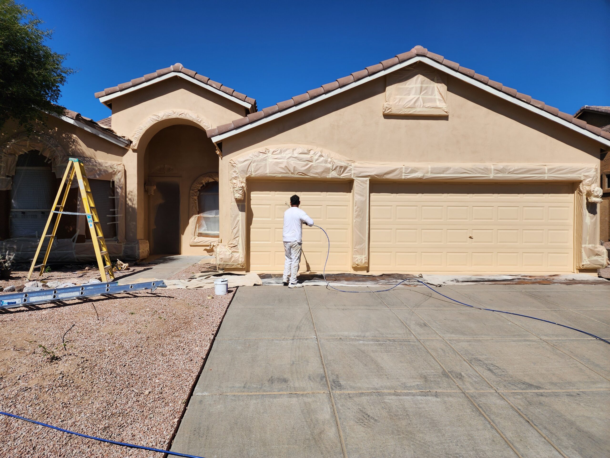 Man Painting a Resudential Home in Mesa, AZ 